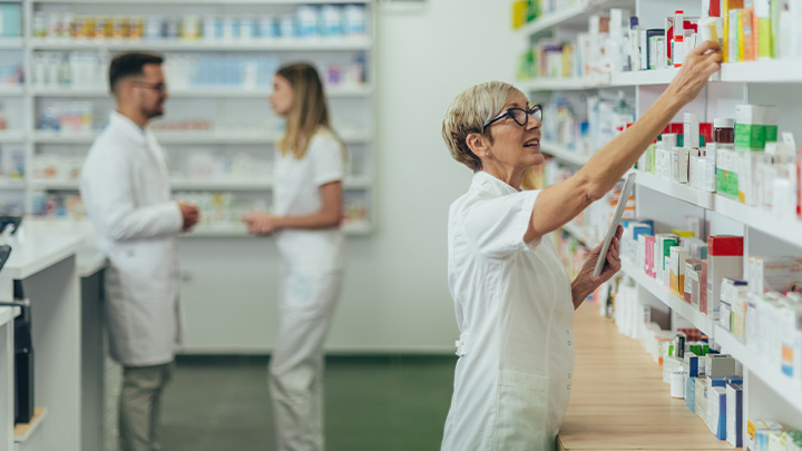 Pharmacist stocking a shelf