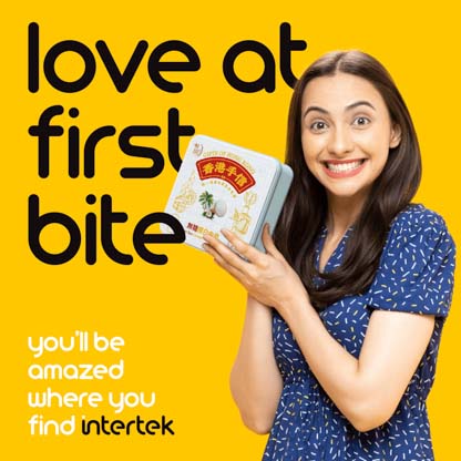 A smiling woman holding a box of cookies